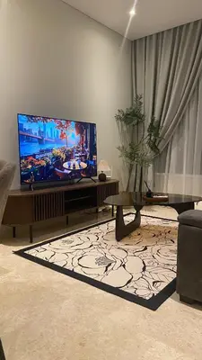 a living room with a large flat screen tv at SkySuites Luxury Suite By CalmSojourn in Kuala Lumpur