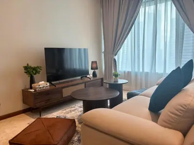 a living room with a couch and a television at SkySuites Luxury Suite By CalmSojourn in Kuala Lumpur