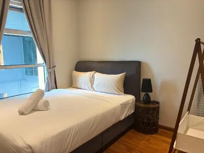 a bedroom with a bed with a large window at SkySuites Luxury Suite By CalmSojourn in Kuala Lumpur
