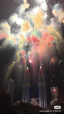a firework display in front of a city with buildings at SkySuites Luxury Suite By CalmSojourn in Kuala Lumpur