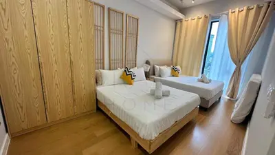 two beds in a room with wood paneling at Sentral 108 Home Brickfields Bangsar Kuala Lumpur 2-5Pax in Kuala Lumpur