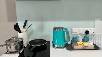 a kitchen counter with a tea kettle and a stove at Sentral 108 Home Brickfields Bangsar Kuala Lumpur 2-5Pax in Kuala Lumpur