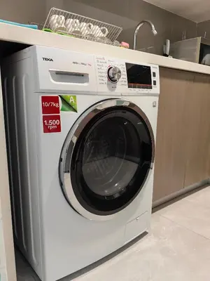 a white washing machine sitting in a kitchen at TRX Agile Bukit Bintang KLCC View 8pax Family Suites in Kuala Lumpur