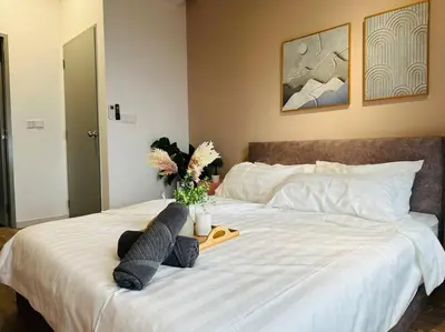 a bed with two pillows and a tray of flowers on it at MVC50#Family Suite 9pax 3 Rooms M Vertica Velocity Mall Cheras in Kuala Lumpur