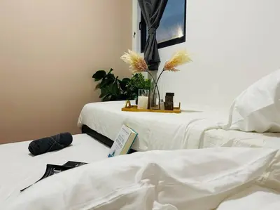 a room with two beds with white sheets and plants at MVC50#Family Suite 9pax 3 Rooms M Vertica Velocity Mall Cheras in Kuala Lumpur