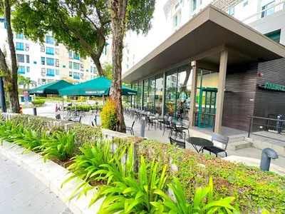 a building with tables and chairs in a city at Neu Suites Junior Suite By Serenity Homes Next to Gleneagles & LRT in Kuala Lumpur