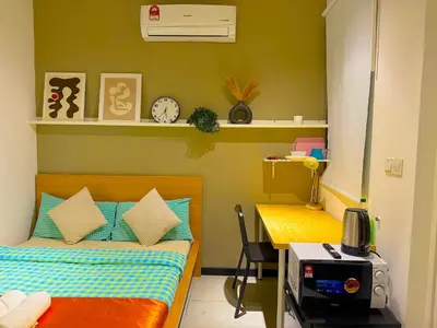 a bedroom with a bed and a desk and a table at Neu Suites Junior Suite By Serenity Homes Next to Gleneagles & LRT in Kuala Lumpur
