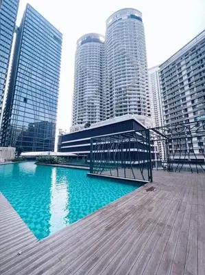 a boardwalk in front of a city with tall buildings at PROMO 2 ROOM Nice Design KL Gateway Residence 27 in Kuala Lumpur