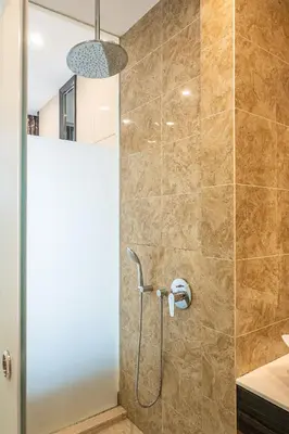 a shower with a shower head in a bathroom at Dorsett 1 min to TRX Pavilion 127 in Kuala Lumpur