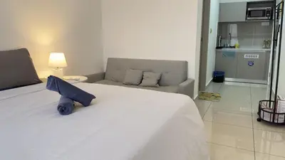 a bedroom with a white bed and a couch at Classic couple suite-Netflix-Free-Park Trion B6205St KL in Kuala Lumpur
