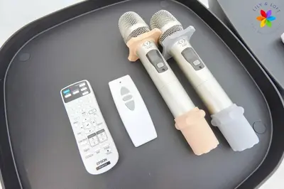a table with microphones and a remote control on it at 30P White House Retreat - Pool & Event Hall in Kuala Lumpur