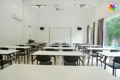 an empty classroom with tables and chairs and a chalkboard at 30P White House Retreat - Pool & Event Hall in Kuala Lumpur