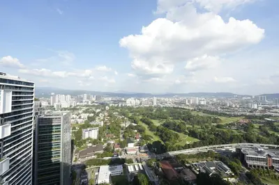 a view of a city with tall buildings and trees at Moonway Luxury Suites At TM KLCC City Center in Kuala Lumpur