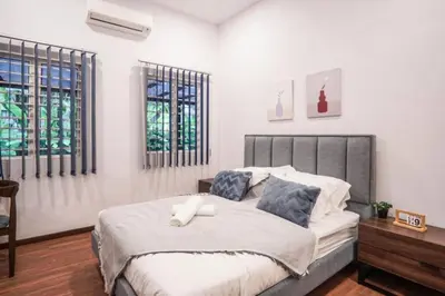 a bedroom with a large bed with blue pillows at The Heritage Mid Valley l KL Sentral l 8 Pax in Kuala Lumpur