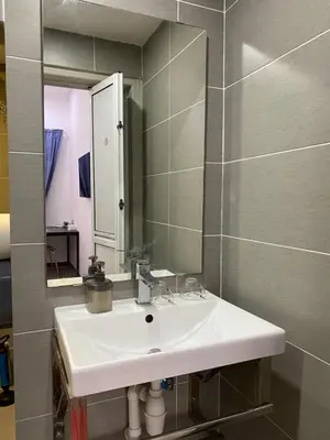 a bathroom with a white sink and a mirror at Miharja Studio Private room with Auto gate Parking in Kuala Lumpur