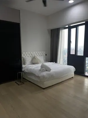 a bedroom with a white bed and a large window at Star Residences One in Kuala Lumpur