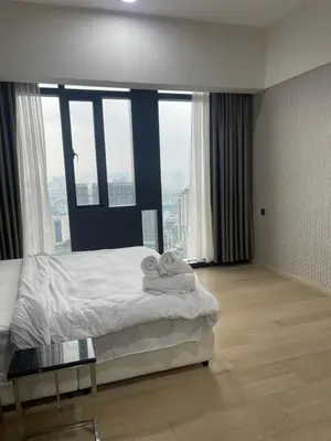 a hotel room with a bed and a glass table at Star Residences One in Kuala Lumpur