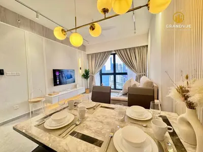 a dining room with a table and a living room at Agile Residence Bukit Bintang By Heystay Management in Kuala Lumpur