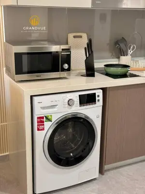 a kitchen with a microwave and a washing machine at Agile Residence Bukit Bintang By Heystay Management in Kuala Lumpur