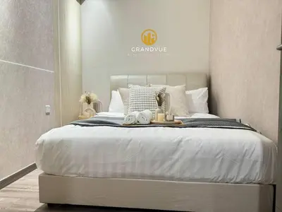a bedroom with a large white bed with towels on it at Agile Residence Bukit Bintang By Heystay Management in Kuala Lumpur