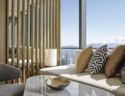 a living room with a couch and a glass table at Park Hyatt Kuala Lumpur in Kuala Lumpur