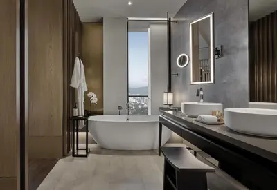 a bathroom with two sinks and a bath tub at Park Hyatt Kuala Lumpur in Kuala Lumpur