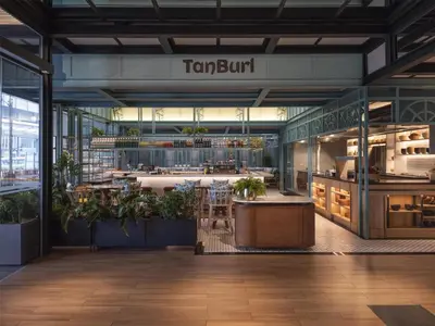 a view of a restaurant with plants in a building at Hyatt Centric City Centre Kuala Lumpur in Kuala Lumpur