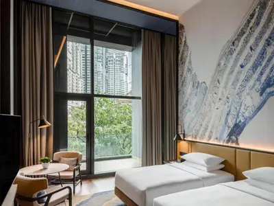 a hotel room with two beds and a window at Hyatt Centric City Centre Kuala Lumpur in Kuala Lumpur