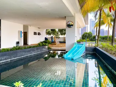 a swimming pool with a blue slide in a building at Continew Residence by Janice's Homestay in Kuala Lumpur