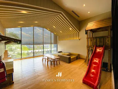 a living room with a slide and a couch at Continew Residence by Janice's Homestay in Kuala Lumpur