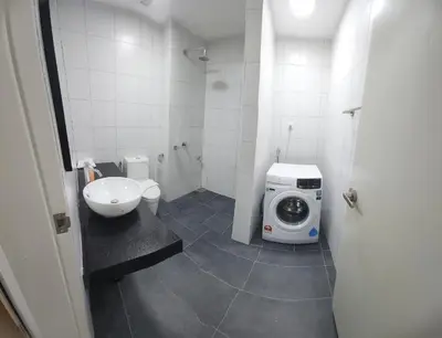 a bathroom with a washing machine and a sink at Chambers Residence Suites Couple Studio in Kuala Lumpur