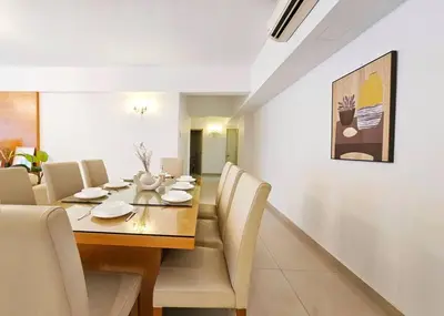 a dining room with a wooden table and chairs at Fahrenheit Bukit Bintang Big Group 13Pax Family Suites in Kuala Lumpur