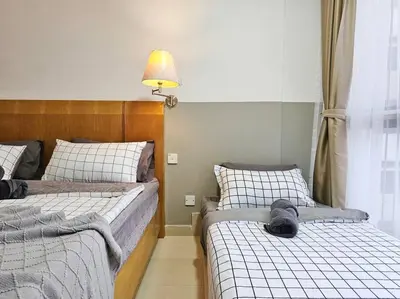 a bedroom with two beds with a dog sleeping on them at Fahrenheit Bukit Bintang Big Group 13Pax Family Suites in Kuala Lumpur