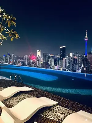 a swimming pool with a view of a city skyline at AXON Residences Kuala Lumpur in Kuala Lumpur