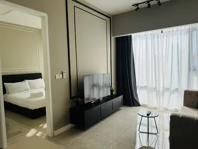 a bedroom with a bed and a tv in a room at AXON Residences Kuala Lumpur in Kuala Lumpur