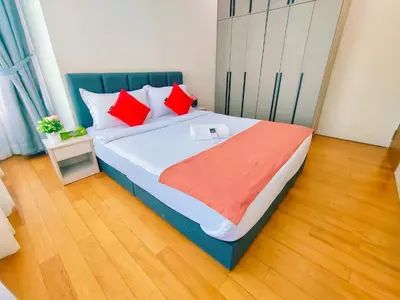 a bedroom with a large bed with red pillows at Sky Suites KLCC by KD Luxury Suites in Kuala Lumpur