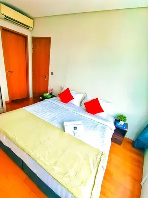 a bedroom with a large bed with red pillows at Sky Suites KLCC by KD Luxury Suites in Kuala Lumpur