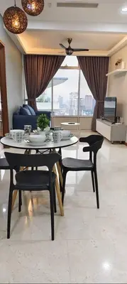 a dining room with a table and chairs and a couch at Sky Suites KLCC by KD Luxury Suites in Kuala Lumpur