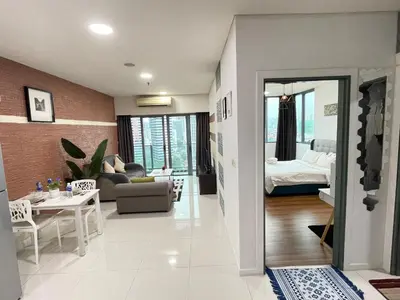 a living room with a couch and a bed at De Home at Summer Suites KLCC in Kuala Lumpur