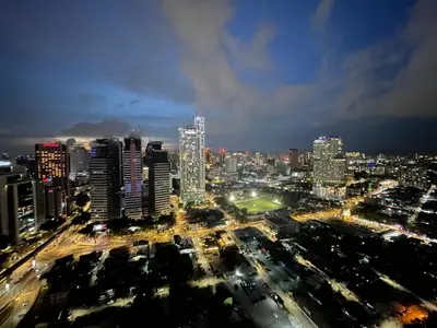 a city skyline at night with traffic and buildings at De Home at Summer Suites KLCC in Kuala Lumpur