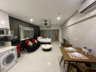 a living room with a couch and a table at De Home at Summer Suites KLCC in Kuala Lumpur