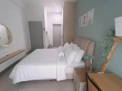 a bedroom with a bed with white sheets and pillows at KLCC View 3BR 3Bath at RC Residence by Rosaz in Kuala Lumpur