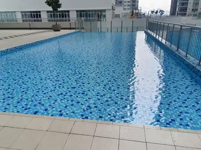 a large blue swimming pool on top of a building at KLCC View 3BR 3Bath at RC Residence by Rosaz in Kuala Lumpur
