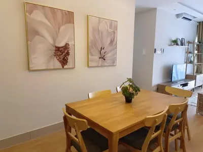 a dining room with a wooden table and chairs at KLCC View 3BR 3Bath at RC Residence by Rosaz in Kuala Lumpur