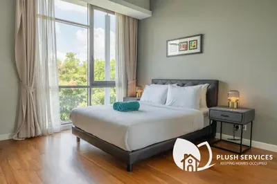 a bedroom with a bed and a large window at The Signature Serviced Apartment at Sri Hartamas in Kuala Lumpur