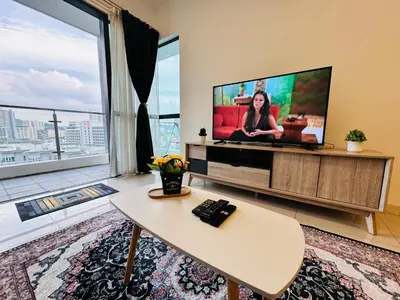 a living room with a tv and a large window at Velocity KL by Homestay in Kuala Lumpur