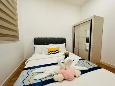 a bedroom with two stuffed animals laying on a bed at Velocity KL by Homestay in Kuala Lumpur