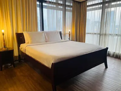 a large bed in a room with windows at Royal empire suite At Times square kl in Kuala Lumpur