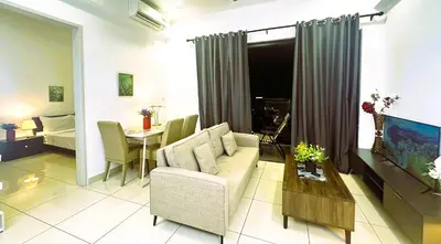 a living room with a couch and a table at KLCC View 1BR cozy suite with Balcony Trion B5310 KL in Kuala Lumpur