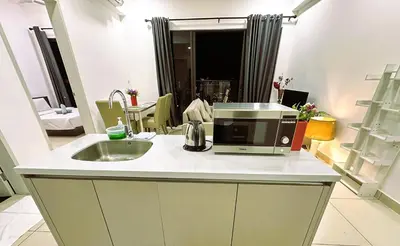 a kitchen with a sink and a microwave on a counter at KLCC View 1BR cozy suite with Balcony Trion B5310 KL in Kuala Lumpur